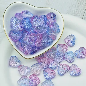 Close-up detail of translucent purple heart-shaped glass beads for DIY jewelry making