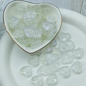 Detail of iridescent heart-shaped glass beads for DIY jewelry making 14x16x7mm