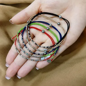 Close-up detail of colorful braided cord bracelets with durable stainless steel beads