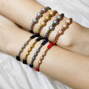 Detailed close-up showing stainless steel frosted beads on woven adjustable knotted bracelets