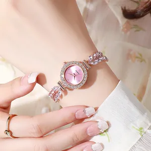Detail shot of an elegant rose gold ladies bracelet watch with leaf rhinestone strap