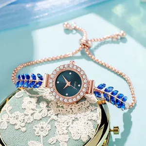 Elegant women's quartz watch detail with adjustable leaf-style blue gem bracelet.