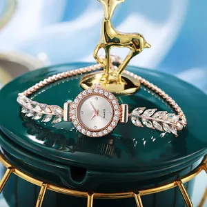 Detailed macro shot of elegant rose gold leaf bracelet watch with sparkling crystals