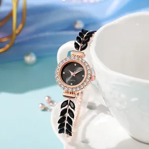Close-up of elegant leaf-shaped rhinestone bracelet watch on white ceramic cup