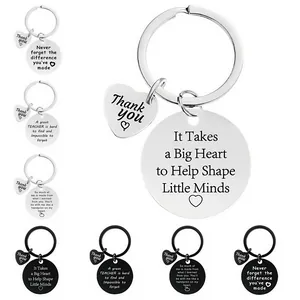 Detailed display of stainless steel teacher keychains with inspirational engraved quotes.