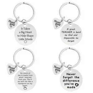 Detailed view of four engraved stainless steel teacher gift keychains with heart charm