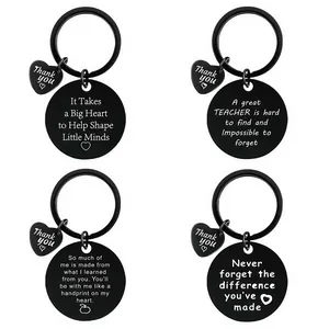 Detail of four black stainless steel keychains with different teacher thank-you quotes.