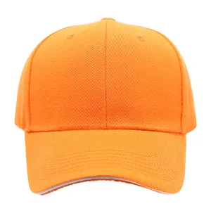 Close-up of a plain orange cotton baseball cap with curved brim and ventilation holes