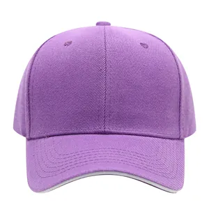 Front view close-up of a plain purple cotton baseball cap featuring curved brim and top eyelets