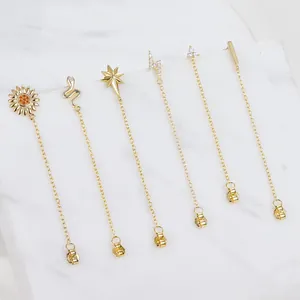 Close-up of gold plated S925 silver earrings set featuring tassel chains and zircon