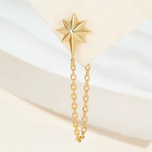 Detailed view of an elegant gold-plated octagram star stud earring with a dangling chain loop