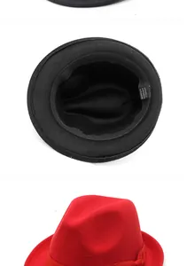Close-up of the black fedora's interior lining and red crown detail with ribbon