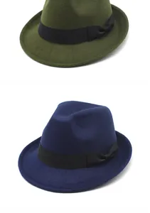 Detail of British retro fedora hats in olive green and navy blue with black bow