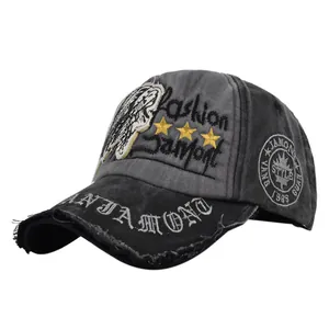 Close-up of vintage washed baseball cap with lion embroidery and 1985 fashion stars