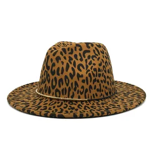 Detail view showing the leopard print pattern and gold band on a wide-brimmed fedora hat.