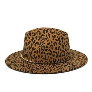 Macro view of leopard print fedora hat featuring elegant gold ring detail and flat brim