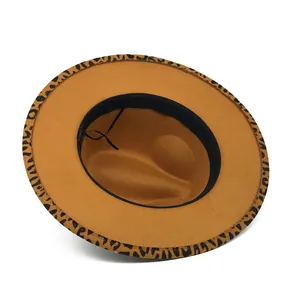 Detailed close-up view of the leopard print trim on a camel wool felt wide brim hat