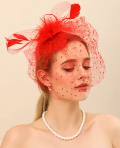 Close-up of an elegant red bridal fascinator with feathers and a polka-dot veil