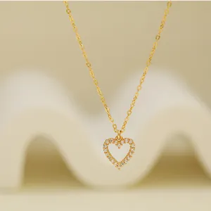 Close-up detail of a minimalist 925 silver heart pendant necklace with shimmering crystals