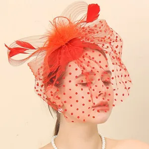 Elegant red bridal fascinator hat with feathers and polka dot mesh face veil for wedding