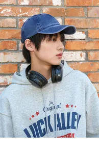 Close-up of a blue washed distressed pure cotton baseball cap worn by a male model