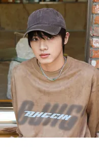 Asian male model wearing washed distressed brown cotton cap and printed sweatshirt