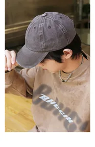 Man wearing a washed distressed cotton baseball cap in a casual indoor setting