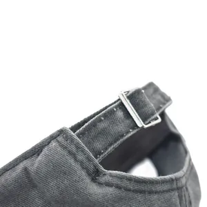 Close-up detail of adjustable metal buckle on washed distressed cotton baseball cap
