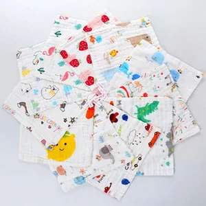 Detailed view of multiple 6-layer cotton gauze baby washcloths with cartoon prints