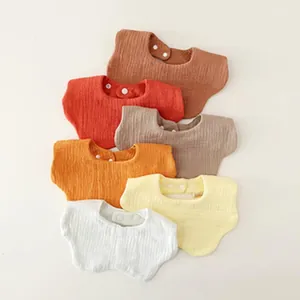 Six colorful soft cotton gauze baby bibs with snap buttons arranged on white background.