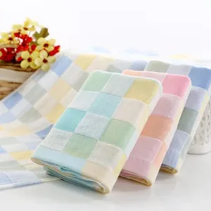 Detail view of soft multi-layer checkered cotton gauze baby blanket texture and colors