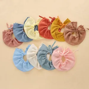 Detailed top-down view of a colorful set of ruffled soft cotton gauze baby bibs set