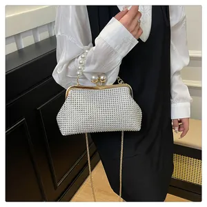 Detail of elegant pearl handle and sparkling rhinestone evening clutch bag for women