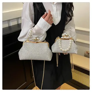 Size comparison of two rhinestone evening bags with pearl handles and gold chains