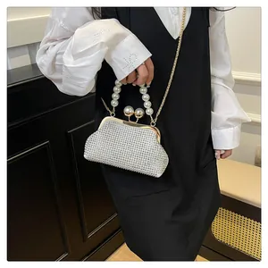 Detailed view of an elegant pearl-handled evening bag with sparkling rhinestone surface