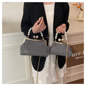 Detailed comparison of large and small rhinestone bags with pearl handles and gold chains