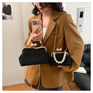 Detailed view of elegant black rhinestone evening clutch bags with large pearl handles