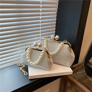Elegant pearl and rhinestone evening bag with oversized pearl handle and gold chain