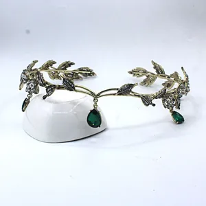 Detailed view of Baroque bat crown with green gems and rhinestones on bronze alloy