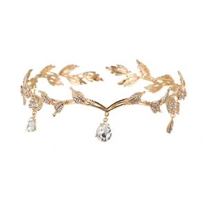 Detailed macro view of baroque gold leaf crown featuring sparkling teardrop crystals and rhinestones