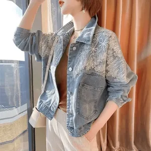 Detailed view of the sparkling sequin and rhinestone embroidery on the blue denim jacket