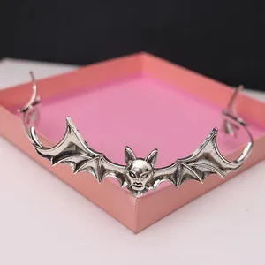 Detail shot of vintage silver alloy bat wing headband for Halloween vampire costumes.