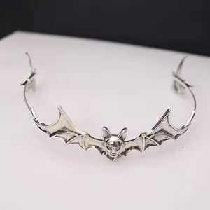 Detailed view of silver gothic bat wing headband with demonic face design for Halloween.