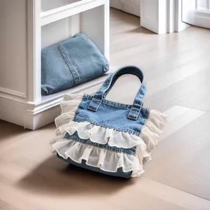 Detail view of washed denim tote bag featuring elegant double-layer white ruffles
