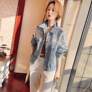 Detailed shot of a light blue denim jacket featuring shimmering sequins and a loose fit