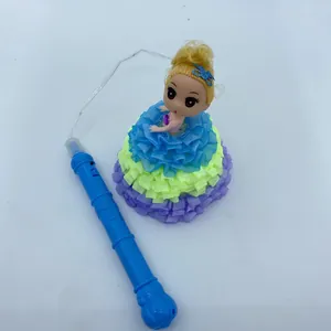 Detalle de una muñeca luminosa con vestido de volantes coloridos y mango azul.