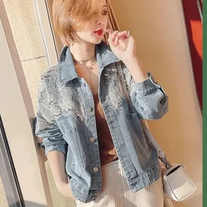 Model wearing a light blue denim jacket with intricate sequin and tassel details.