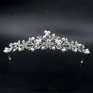 Detailed macro view of elegant silver baroque tiara with pearls and rhinestones for party.