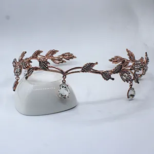 Baroque alloy crown featuring intricate leaf motifs and hanging teardrop crystals