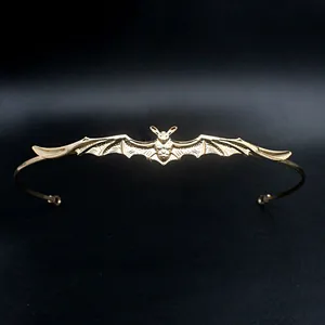 Detailed view of the gold-colored bat motif on this Baroque style metal headband accessory
